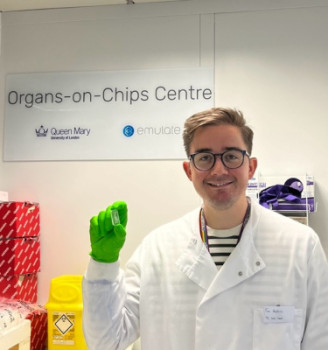 Dr Timothy Hopkins holding an organ-chip in the lab/