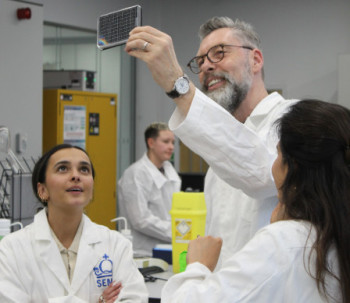 Representatives from Lush examining an organ-chip plate